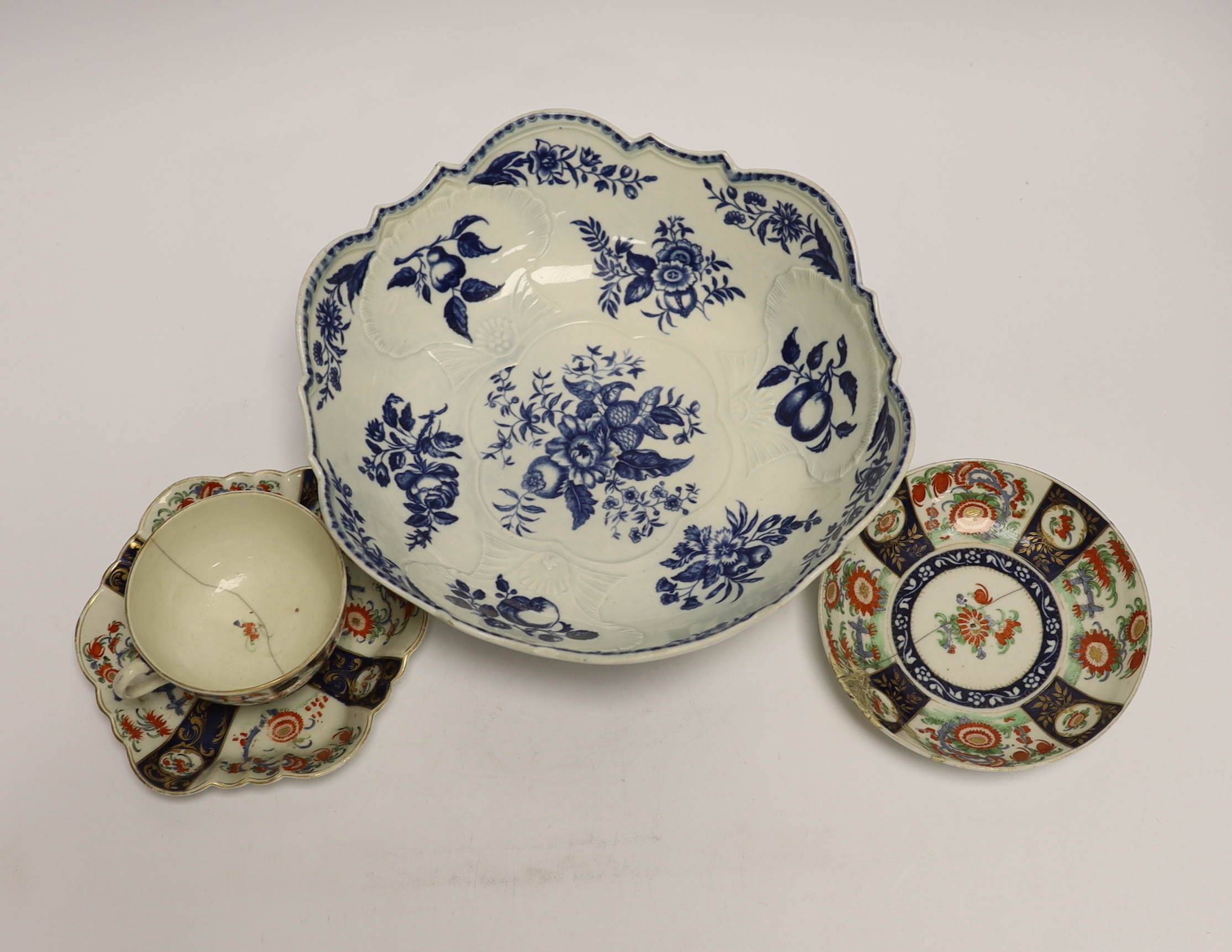 A Worcester Pine Cone pattern junket dish, c.1775, the shell moulded interior with other panels of fruit and flowers, the exterior printed with vegetables and a snail, shaded crescent mark, diameter 24.5cm Together with